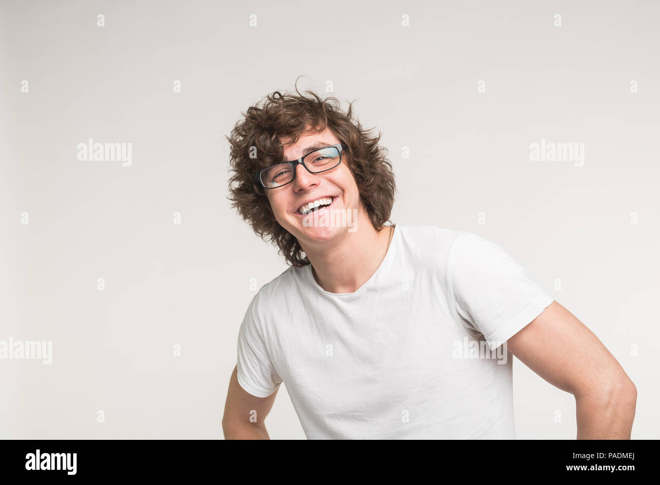 Portrait of laughing stylish student guy in glasses and casual outfit ...
