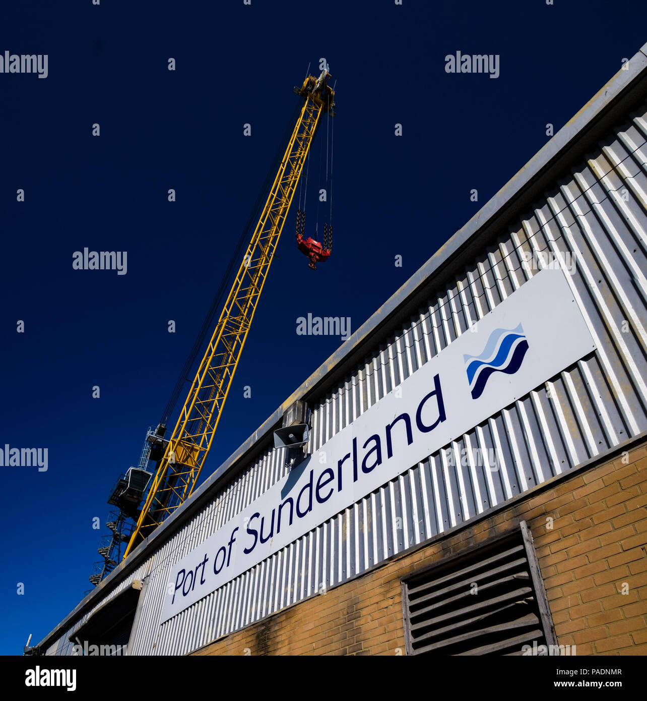 A crane towers above a warehouse building at the Port of Sunderland in the city in the north east of England. Stock Photo