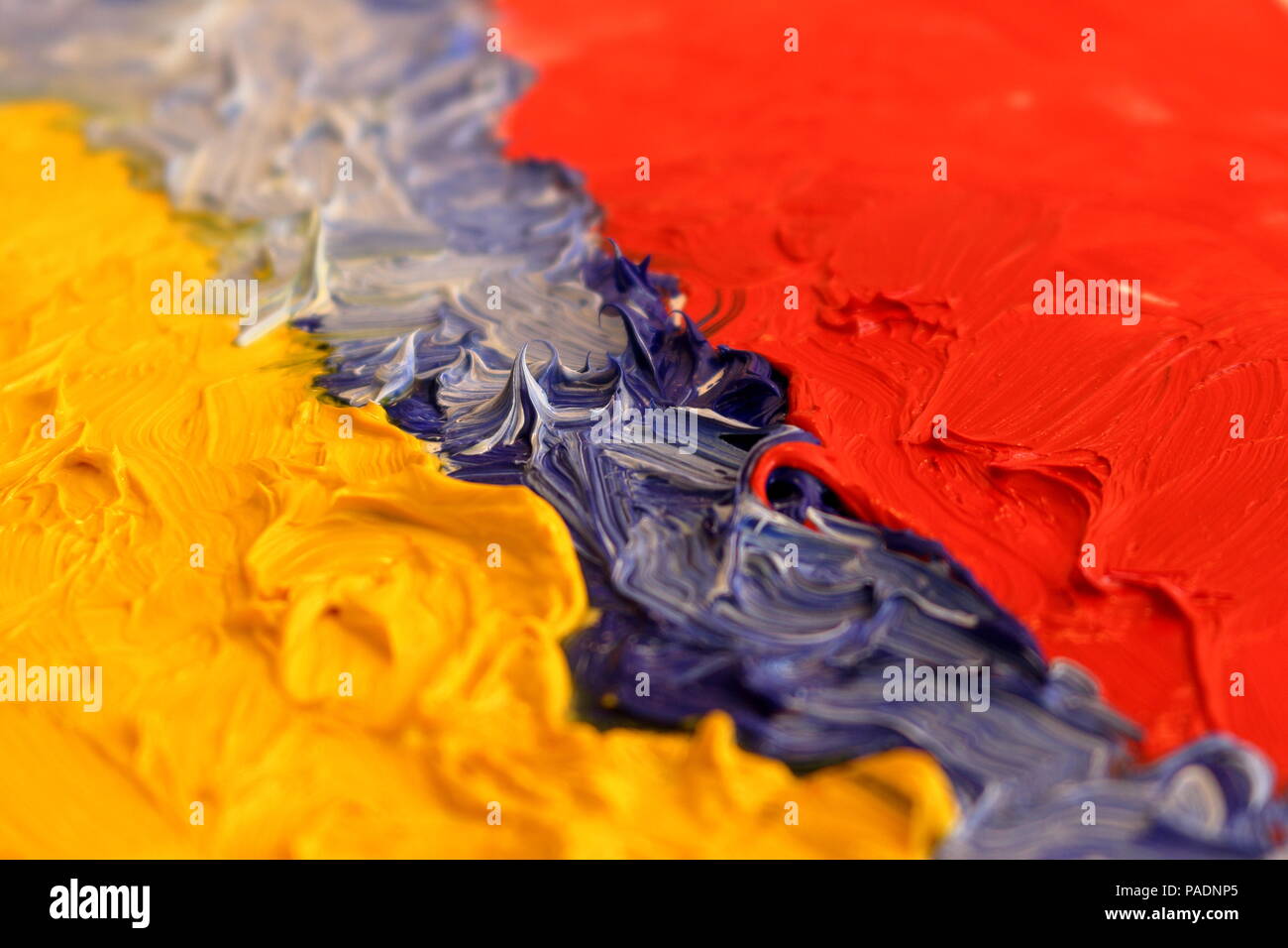 Extreme closeup of yellow, blue and red oil paints Stock Photo