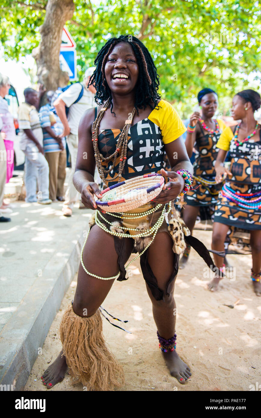 ANGOLA, LUANDA - MARCH 4, 2013: A smiling Angolan woman dances the local  falk dance and collects money in Angola, Mar 4, 2013. Music is one of the  mai Stock Photo - Alamy