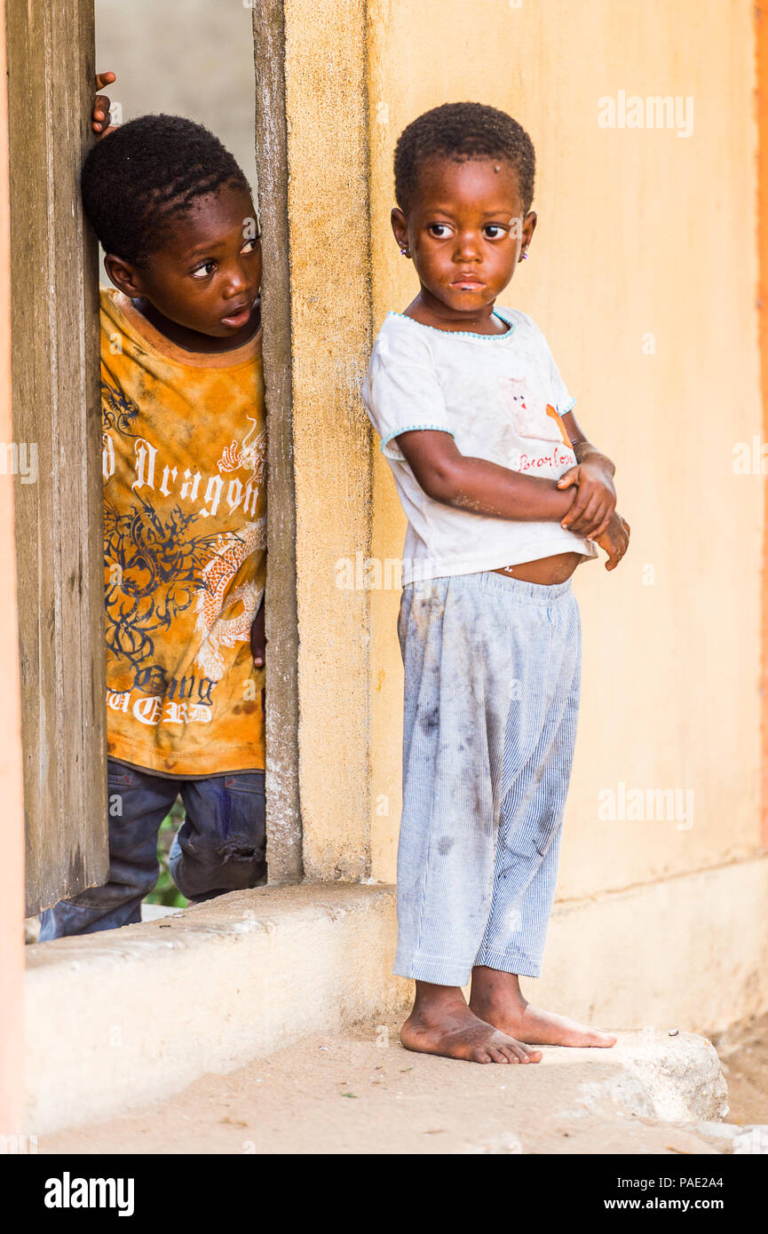 LOME, TOGO - MAR 9, 2013: Unidentified Togolese two little girls near a