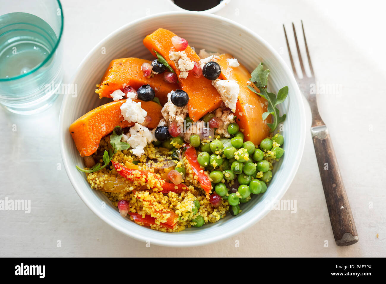 Couscous, red peppers, peas with butternut squash, blueberries and goat's cheese salad Stock Photo