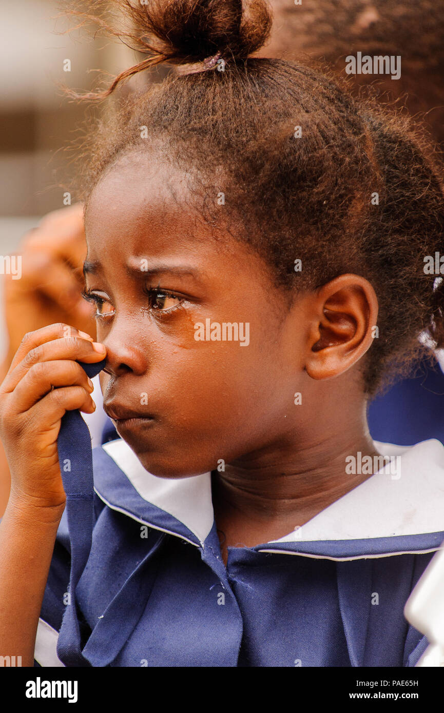 ACCRA, GHANA - MARCH 4, 2012: Unidentified Ghanaian girl cries in a school uniform in Ghana. School uniform is a part of the humanitarian help to Afri Stock Photo