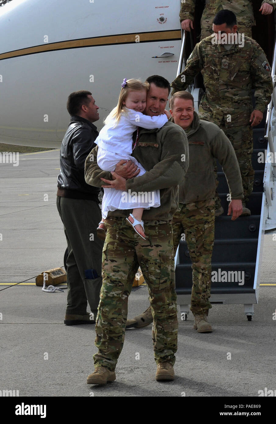 Airmen reunite with their families after returning from a deployment March 15, 2016, at Ramstein Air Base, Germany. The 76th Airlift Squadron Airmen aided an important mission by providing executive airlift and aeromedical evacuation. (U.S. Air Force photo/Airman 1st Class Larissa Greatwood) Stock Photo