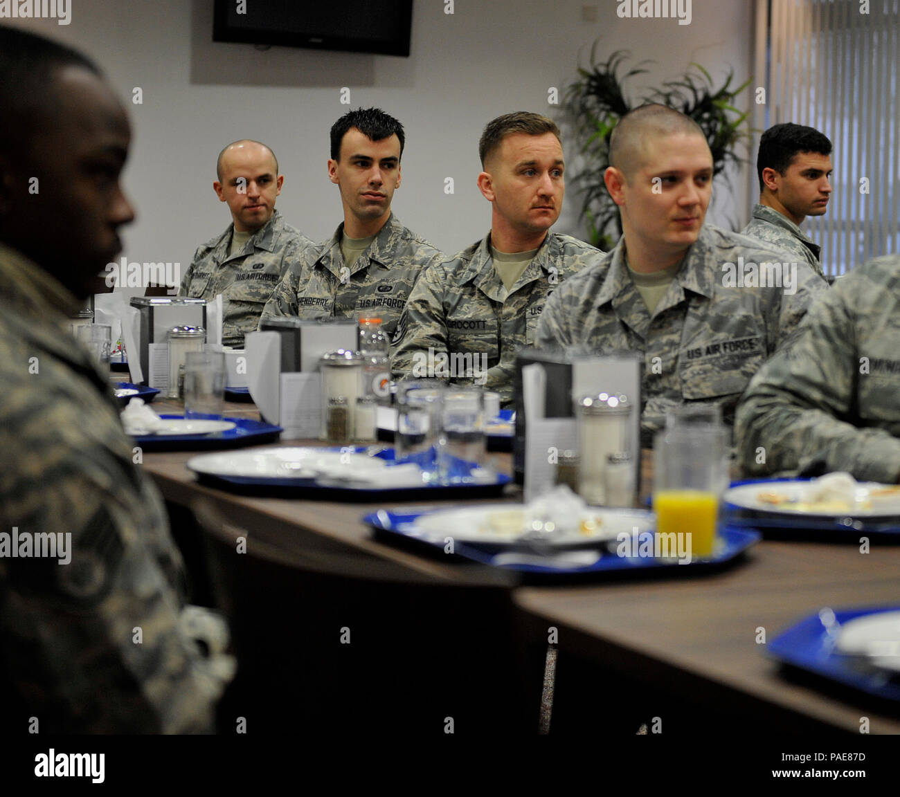Airmen listen as Chief Master Sgt. Phillip L. Easton, 86th Airlift Wing command chief, tells Airmen about his experiences during an enlisted breakfast March 11, 2016, at Kapaun Air Station, Germany. Airmen met with Easton and learned the importance of the whole-Airman concept. (U.S. Air Force photo/Airman 1st Class Larissa Greatwood) Stock Photo