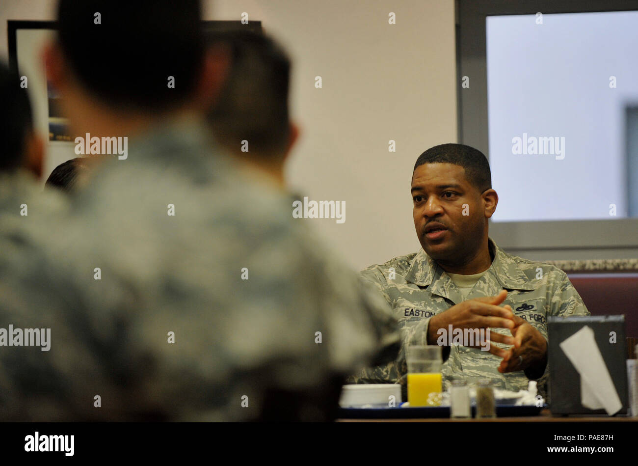 Chief Master Sgt. Phillip L. Easton (right), 86th Airlift Wing command chief, answers an Airman’s question during an enlisted breakfast  March 11, 2016, at Kapaun Air Station, Germany. Easton talked to the Airmen about his priorities and offered his experiences for becoming better Airmen. (U.S. Air Force photo/Airman 1st Class Larissa Greatwood) Stock Photo