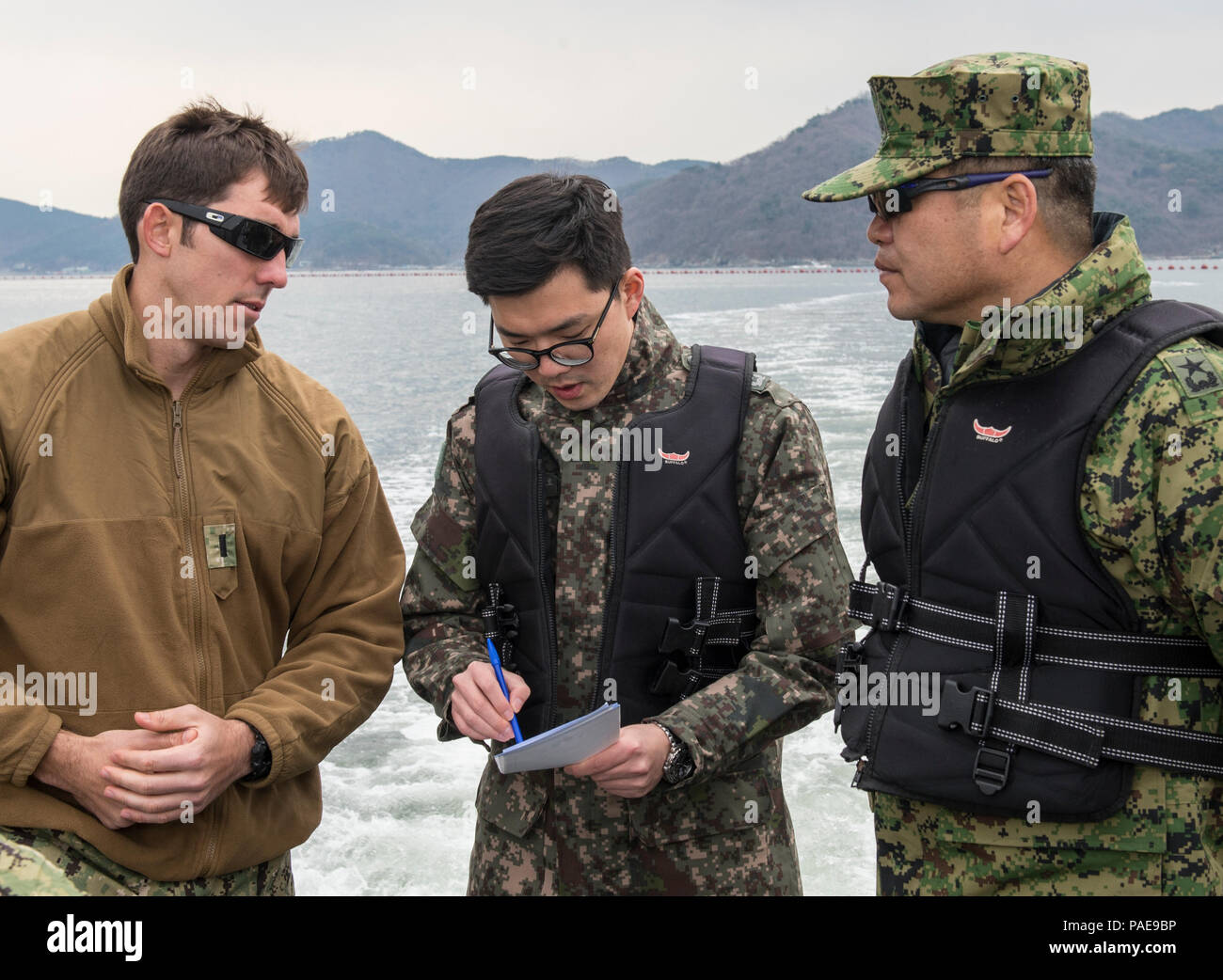 U.S. Navy Lt. j.g. Christopher Gallardo (left), assigned to Explosive Ordnance Disposal Mobile Unit (EODMU) 5, speaks with Republic of Korea (ROK) Rear Adm. Jae Eun Lee (right), commander, ROK Naval Special Warfare Flotilla, off the coast of Jinhae, ROK March 24, 2016, during exercise Foal Eagle 2016. Foal Eagle is an annual, bilateral training exercise designed to enhance the readiness of U.S. and ROK forces, and their ability to work together during a crisis. (U.S. Navy combat camera photo by Mass Communication Specialist 1st Class Charles E. White/Released) Stock Photo