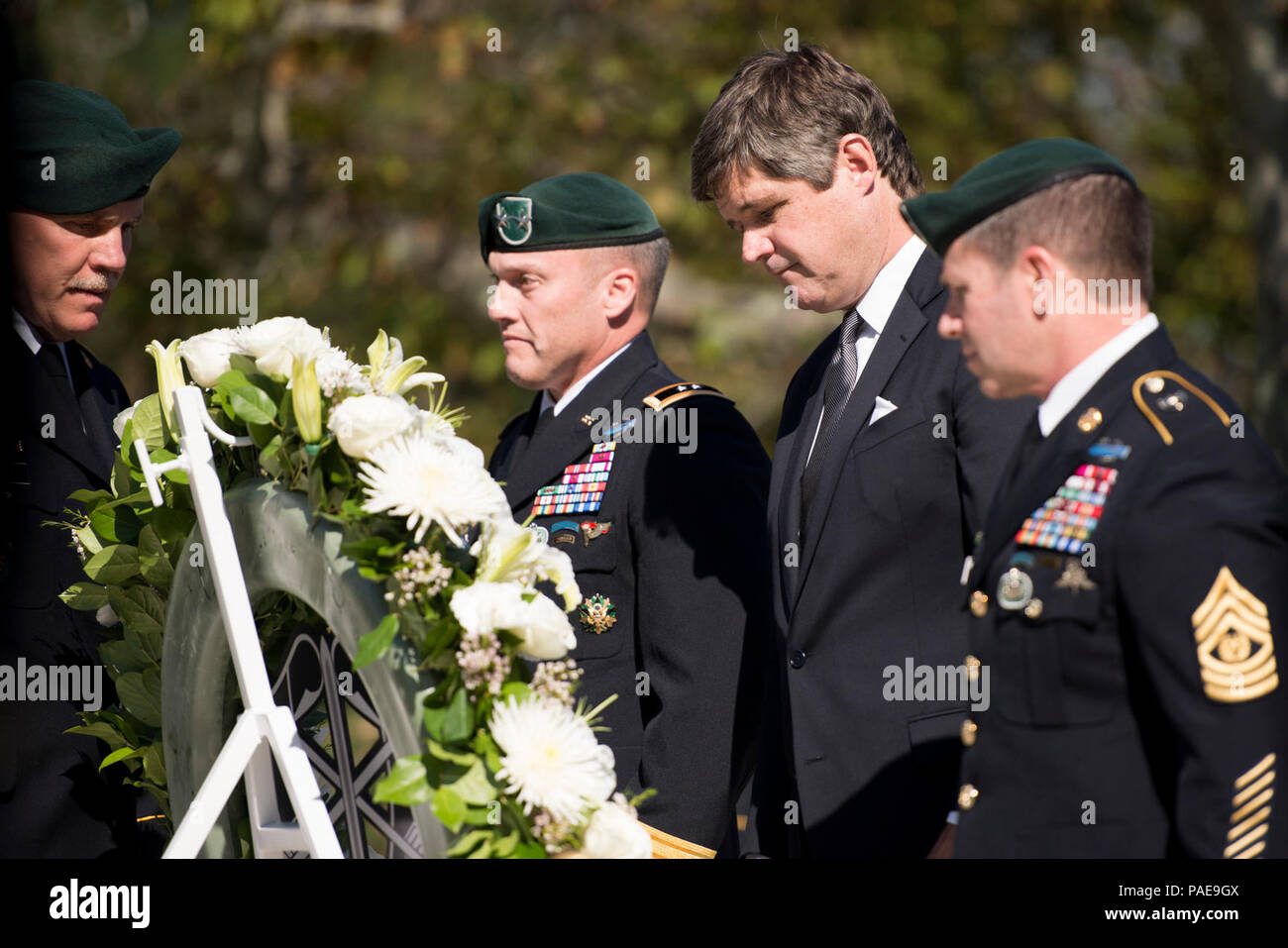 Commanding General of 1st Special Forces Command (Airborne)(Provisional) Maj. Gen. James E. Kraft Jr., President John F. Kennedy’s nephew Dr. William Kennedy Smith and 1st Special Forces Command (Airborne)(Provisional) Command Sgt. Maj. Brian C. Rarey lay a wreath at the gravesite of President John F. Kennedy in Arlington National Cemetery, Oct. 20, 2015, in Arlington, Va. Kennedy contributed greatly to the Special Forces, including authorizing the “Green Beret” as the official headgear for all U.S. Army Special Forces. Stock Photo