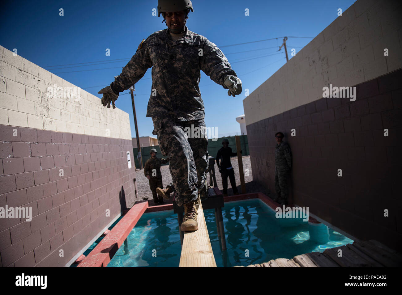 Sgt. Maj. Kimala Cox, stationed at Joint Base Lewis-McChord, Wash., crosses a leadership reaction course obstacle during Operational Contract Support Joint Exercise 2016, March 24, 2016, at Fort Bliss, Texas. This exercise provides training across the spectrum of OCS readiness from requirements and development of warfighter staff integration and synchronization through contract execution supporting the joint force commander.  (U.S. Air Force photo by Tech. Sgt. Manuel J.Martinez/Released) Stock Photo