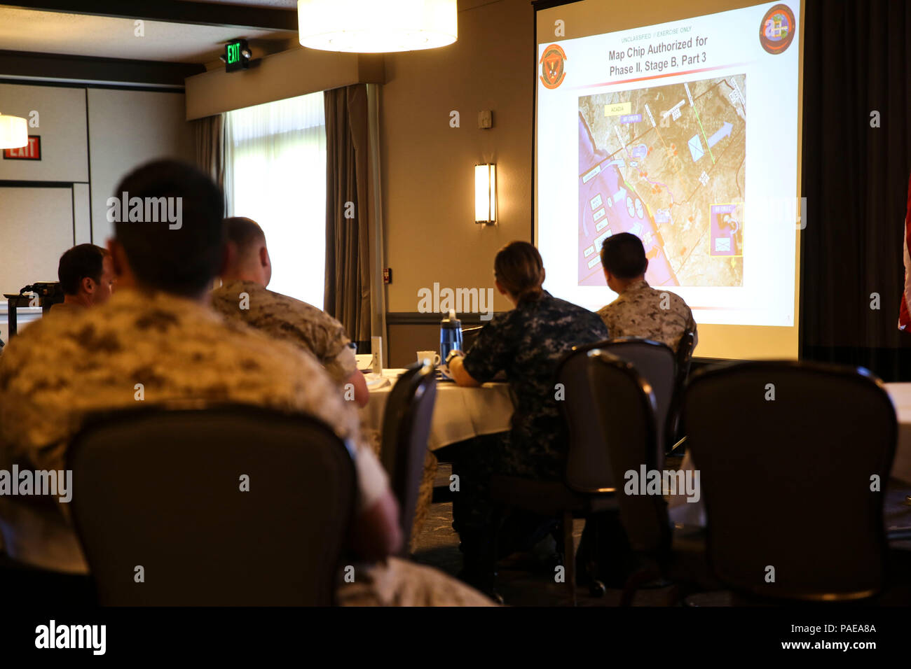 Navy medical personnel receive instruction before beginning the