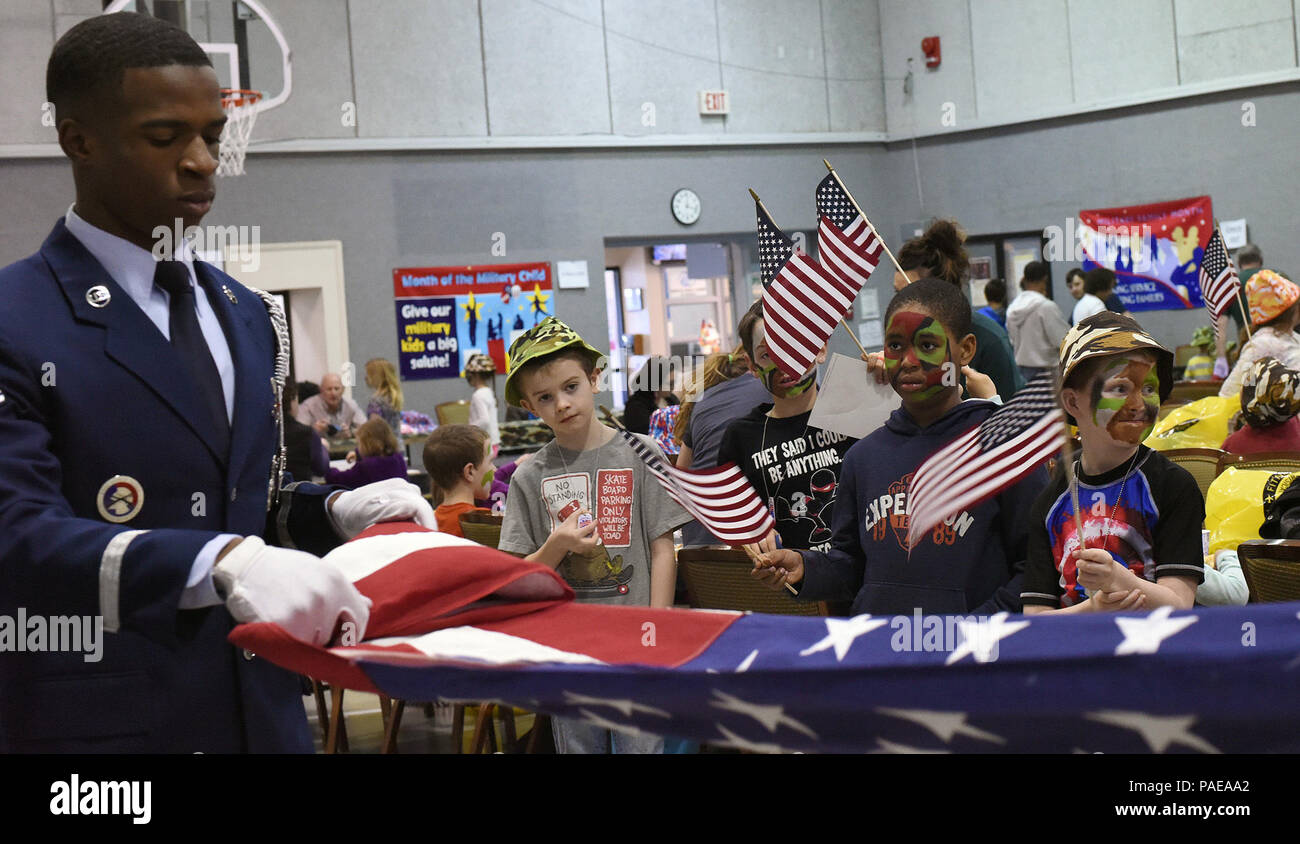 Airman 1st Class Alexander Turner, Malmstrom Honor Guard member, demonstrates a flag folding at the junior deployment line March 23, 2016, at Malmstrom Air Force Base, Mont. The 341st Force Support Squadron hosted the junior deployment to give kids a chance to see what their parents go through before deploying. (U.S. Air Force photo/Senior Airman Jaeda Tookes) Stock Photo