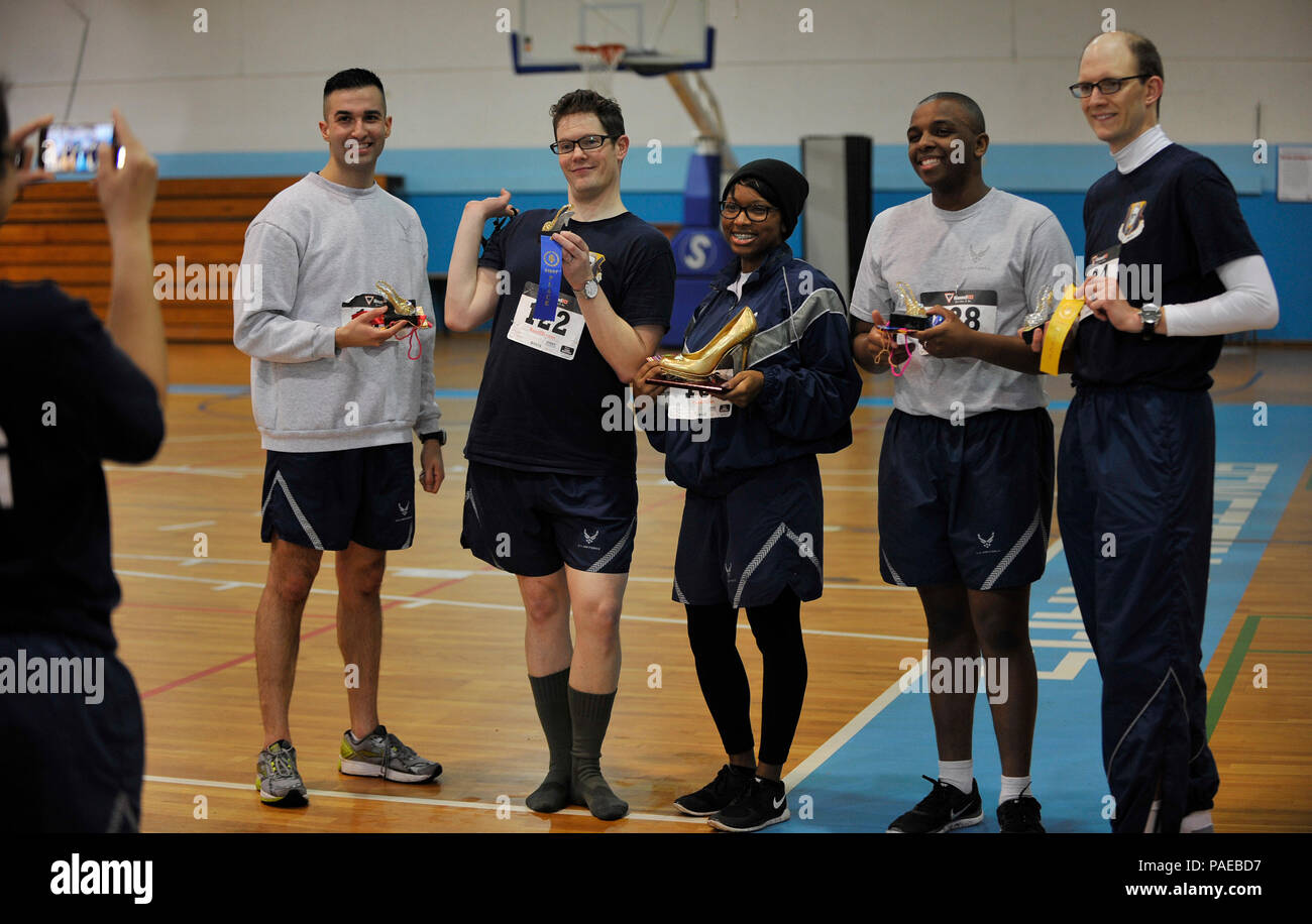 Airmen pose for a photo with their trophies after competing in the first One Mile Walk in Her Heels and 5K Run March 25, 2016, at Ramstein Air Base, Germany. Men and women participated in the event to show their support for women’s equality. (U.S. Air Force photo/Airman 1st Class Larissa Greatwood) Stock Photo