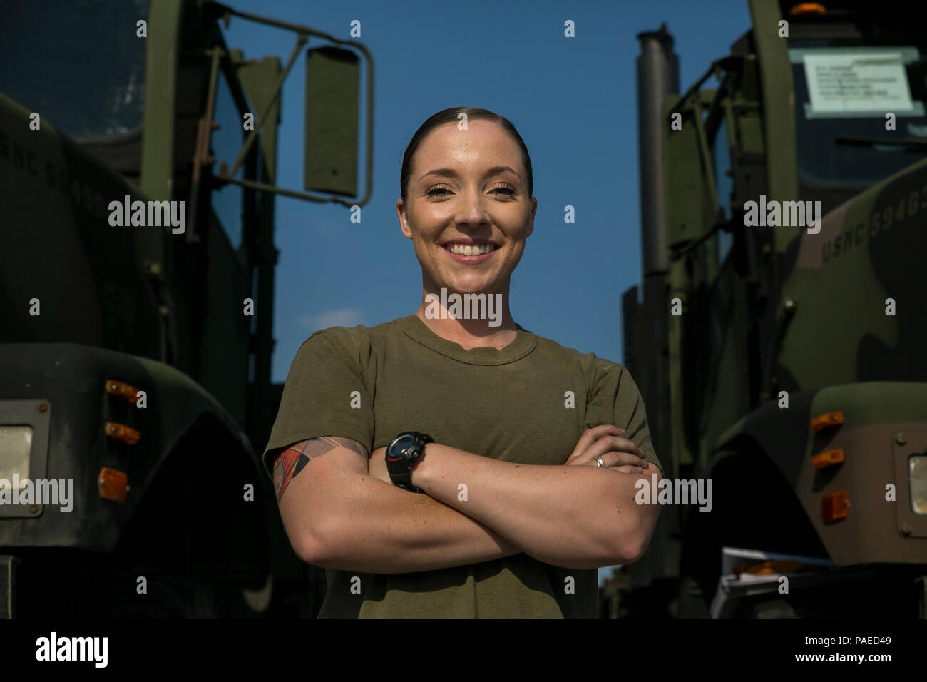 Lance Cpl. Emilee Kohls poses for a portrait at the III Marine Expeditionary Force Headquarters Group Motor Pool on Camp Hansen, Okinawa, Japan, March 28, 2016. III MHG motor transport Marines turn wrenches and drive day and night to ensure III MEF’s ability to deploy at any time. Kohls, from Meeker, Colo., is a motor transportation operator with III MHG. (U.S. Marine Corps photo by Cpl. Steven Tran/Released) Stock Photo