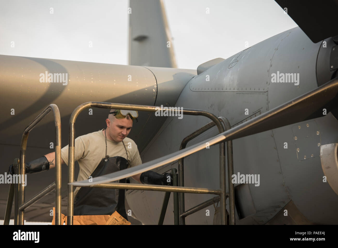 Senior Airman Alexander Matej, 455th Expeditionary Aircraft Maintenance Squadron crew chief, climbs a lift to top off the oil on a C-130J Super Hercules at Bagram Airfield, Afghanistan, March 29, 2016. Members of the 455th EAMXS ensure that aircraft at Bagram are prepared for flight and return them to a mission-ready state once they land. (U.S. Air Force photo/Tech. Sgt. Robert Cloys) Stock Photo