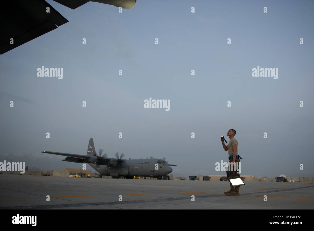 Senior Airman Alec Flores, 455th Expeditionary Aircraft Maintenance Squadron crew chief, visually inspects a C-130J Super Hercules during a basic post- and pre-flight combo inspection at Bagram Airfield, Afghanistan, March 29, 2016. Members of the 455th EAMXS ensure that aircraft at Bagram are prepared for flight and return them to a mission-ready state once they land. (U.S. Air Force photo/Tech. Sgt. Robert Cloys) Stock Photo