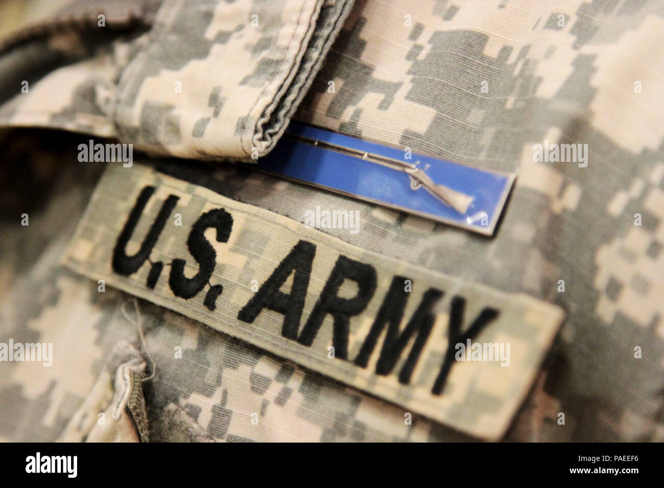 A Soldier from the 4th Infantry Division displays his Expert Infantryman  Badge during the award ceremony on March 18, 2016. The EIB was established  in 1944 by Army Chief of Staff George