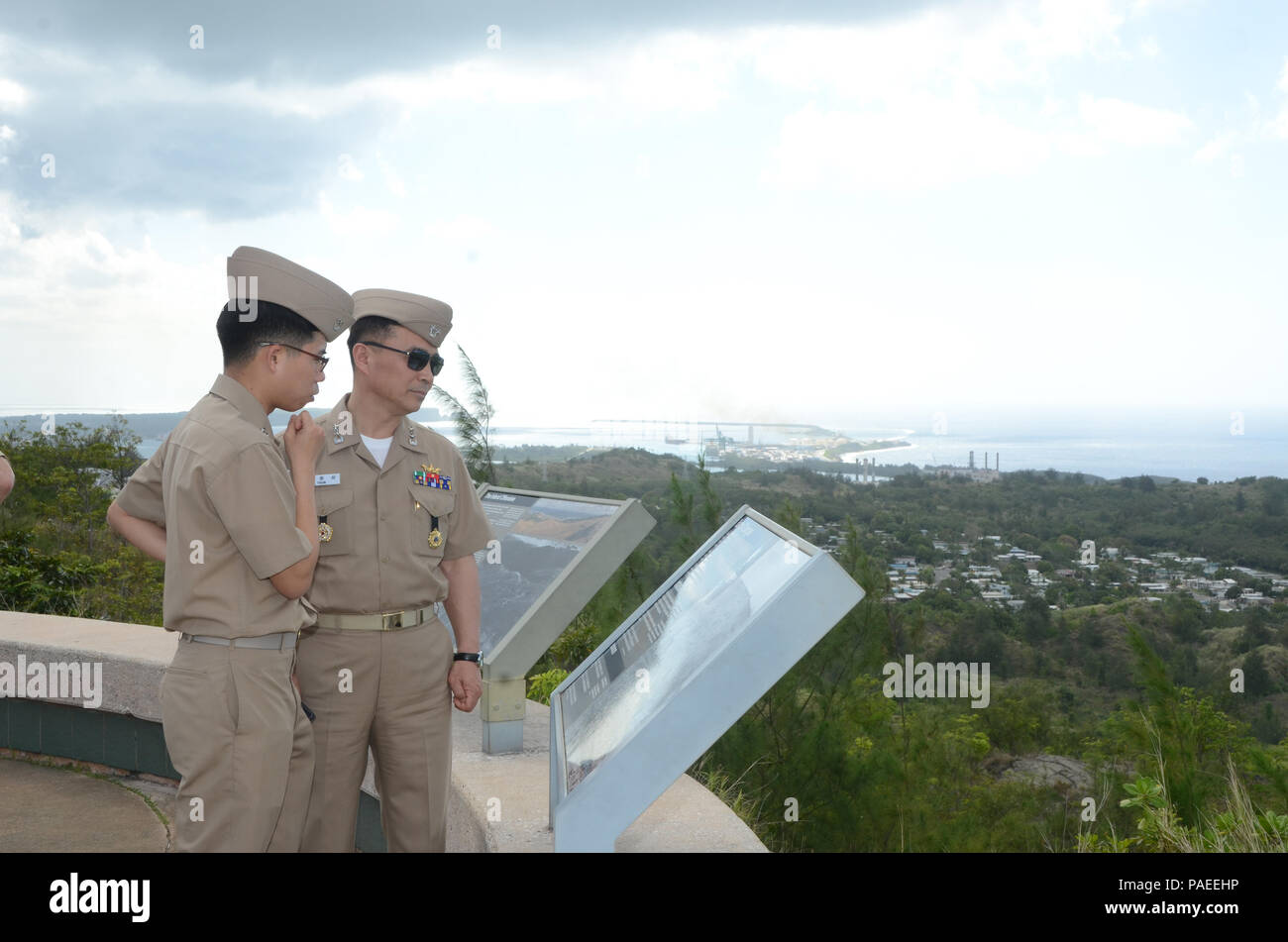 160331-N-YM720-242 SANTA RITA, Guam (March 31, 2016) Rear Adm. Youn Jeong Sang, commander, Submarine Force, Republic of Korea Navy (ROKN), right, and Lt.j.g. Hyung Tae 'Daniel' Kim, ROKN, read a sign at the Asan Bay Overlook on Nimitz Hill after the first day of the Submarine Warfare Committee Meeting (SWCM) the following two days. SWCM is a bilateral discussion between the U.S. and ROKN submarine forces designed to foster the partnership and focuses on submarine tactics, force integraton and future submarine development. (U.S. Navy photo by MC3 Allen McNair/Released) Stock Photo