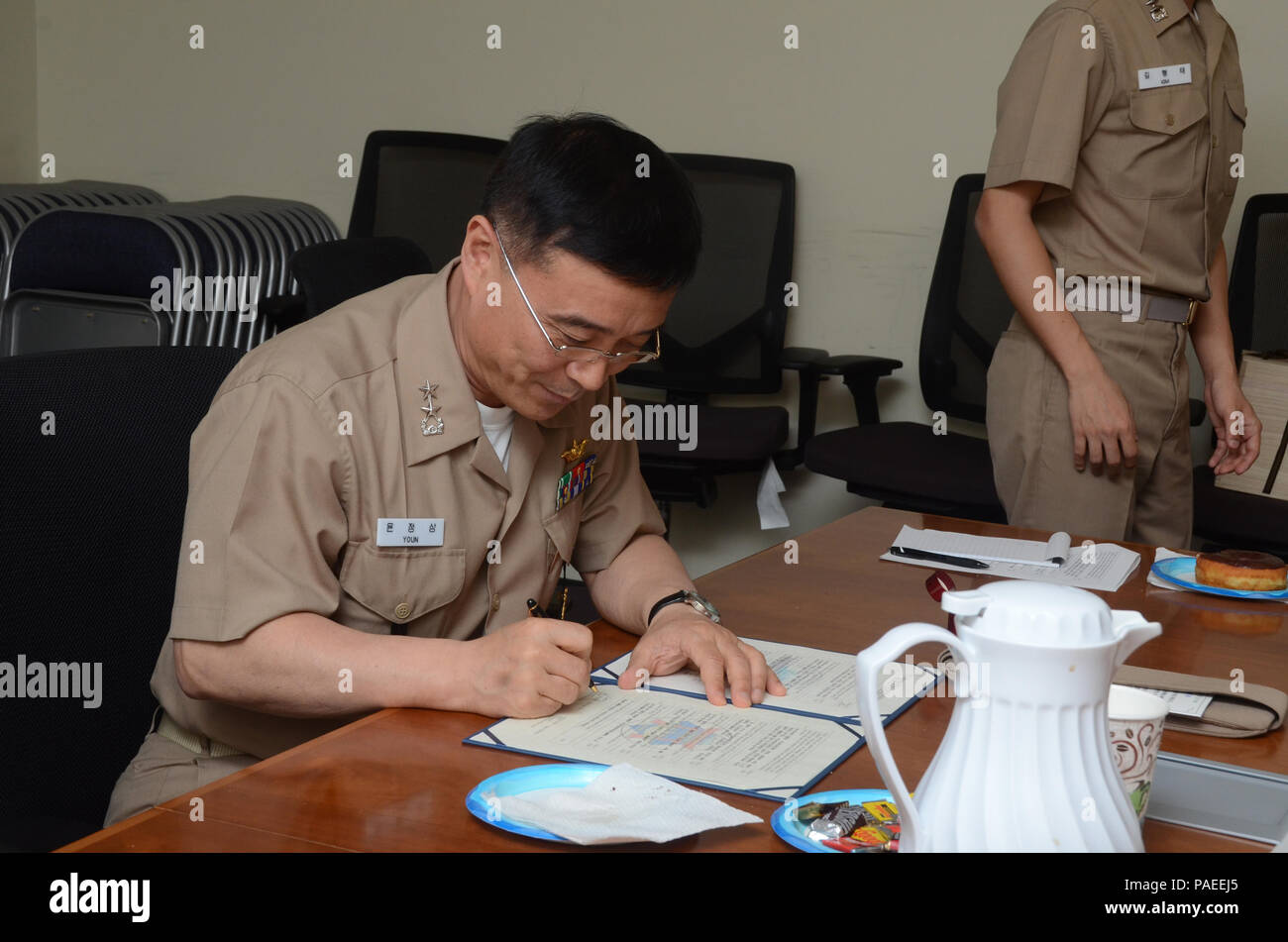 160331-N-YM720-260 SANTA RITA, Guam (March 31, 2016) Rear Adm. Youn Jeong Sang, commander, Submarine Force, Republic of Korea Navy (ROKN), signs a formal agreement at the conclusion of the 43rd Submarine Warfare Committee Meeting (SWCM) reaffirming the longstanding relationship between the U.S. and ROKN and pledging continued support between the two submarine forces. SWCM is a bilateral discussion between the U.S. and ROKN submarine forces designed to foster the partnership and focuses on submarine tactics, force integraton and future submarine development. (U.S. Navy photo by MC3 Allen McNair Stock Photo