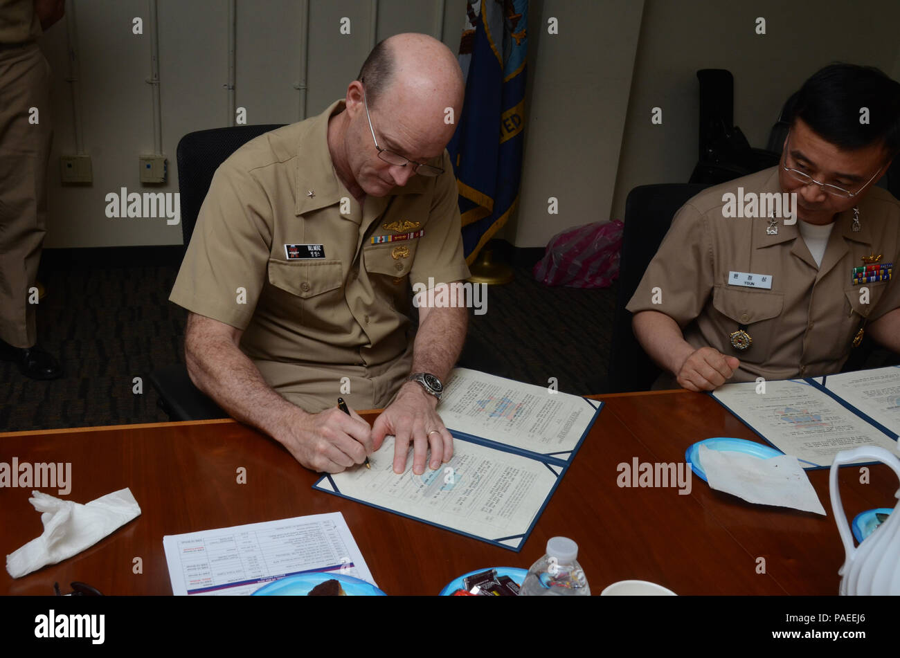 160331-N-YM720-263 SANTA RITA, Guam (March 31, 2016) Rear Adm. William Merz, commander, Submarine Group 7, left, and Rear Adm. Youn Jeong Sang, commander, Submarine Force, Republic of Korea Navy (ROKN), sign a formal agreement at the conclusion of the 43rd Submarine Warfare Committee Meeting (SWCM) reaffirming the longstanding relationship between the two countries and pledging continued support between the two submarine forces. SWCM is a bilateral discussion between the U.S. and ROKN submarine forces designed to foster the partnership and focuses on submarine tactics, force integraton and fut Stock Photo