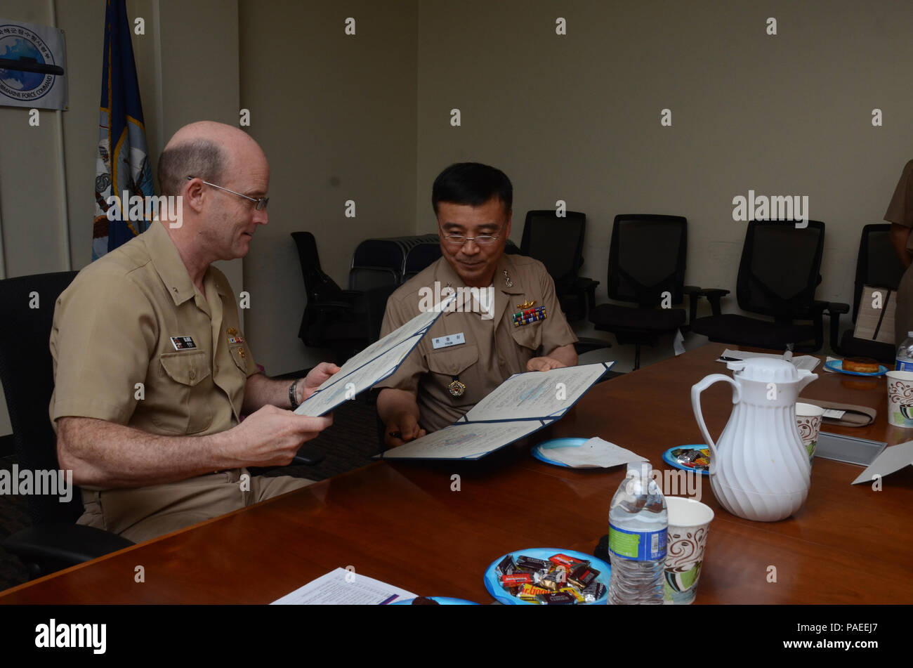 160331-N-YM720-264 SANTA RITA, Guam (March 31, 2016) Rear Adm. William Merz, commander, Submarine Group 7, left, and Rear Adm. Youn Jeong Sang, commander, Submarine Force, Republic of Korea Navy (ROKN), sign a formal agreement at the conclusion of the 43rd Submarine Warfare Committee Meeting (SWCM) reaffirming the longstanding relationship between the two countries and pledging continued support between the two submarine forces. SWCM is a bilateral discussion between the U.S. and ROKN submarine forces designed to foster the partnership and focuses on submarine tactics, force integraton and fut Stock Photo