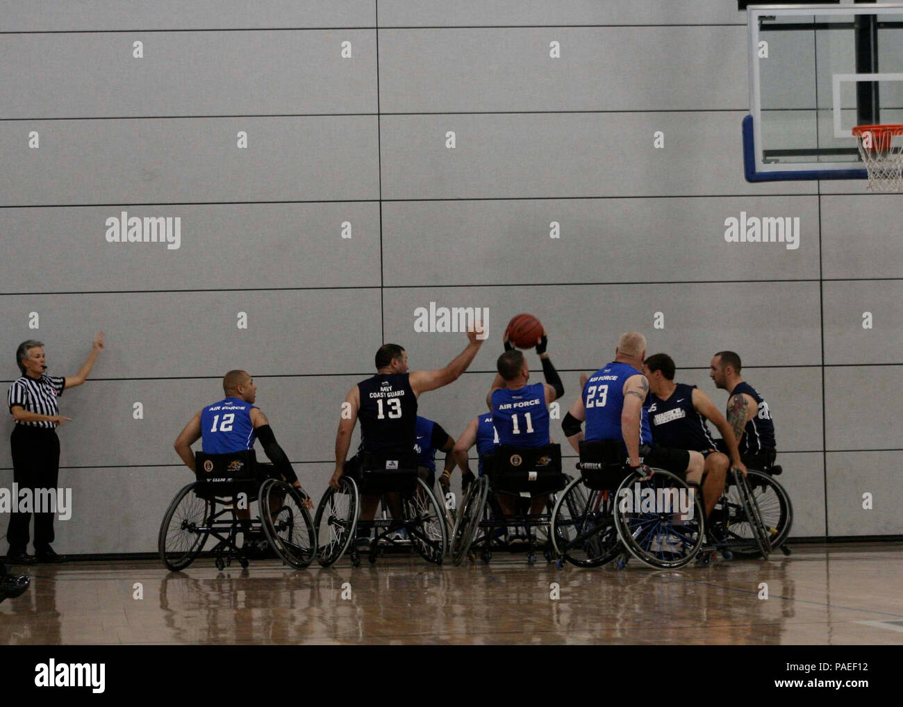 Team Navy/Coast Guard members strategically position themselves in a game of wheelchair basketball  against Team Air Force during the 2013 Warrior Games May 14. The Warrior Games includes competitions in archery, cycling, seated volleyball, shooting, swimming, track and field, and wheelchair basketball. The goal of the Warrior Games is not necessarily to identify the most skilled athletes, but rather to demonstrate the incredible potential of wounded warriors through competitive sports. More than 200 wounded, ill, or injured service members from the U.S. and U.K. armed forces are scheduled to  Stock Photo