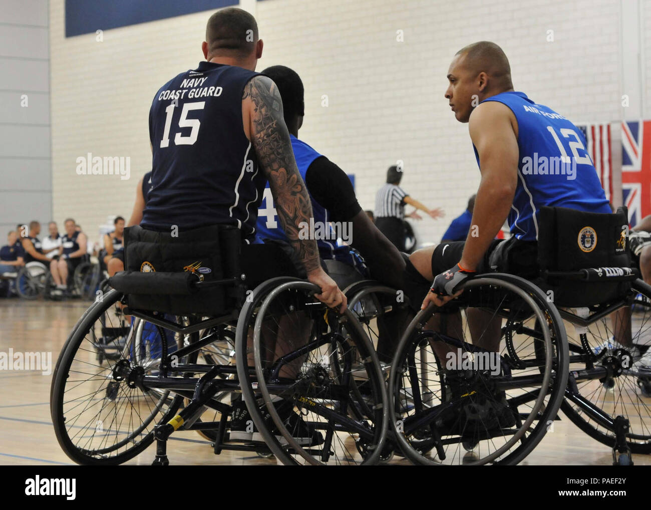 Team Navy/Coast Guard member retired Aviation Electrician's Mate Steven Davis of Turlock, Calif., blocks opposing team members in a wheelchair basketball game against Team Air Force during the 2013 Warrior Games May 14. The Warrior Games includes competitions in archery, cycling, seated volleyball, shooting, swimming, track and field, and wheelchair basketball. The goal of the Warrior Games is not necessarily to identify the most skilled athletes, but rather to demonstrate the incredible potential of wounded warriors through competitive sports. More than 200 wounded, ill, or injured service me Stock Photo