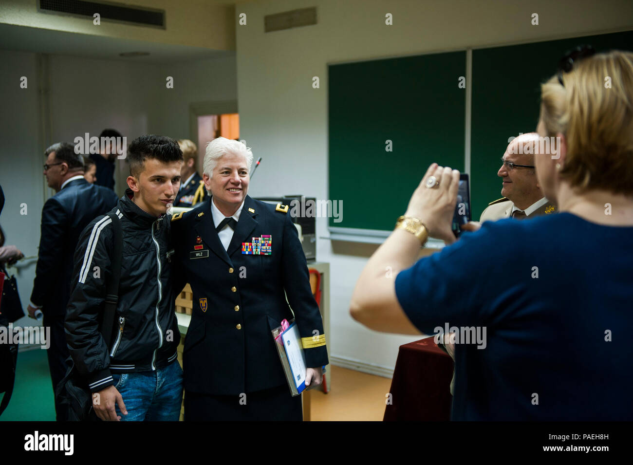 U.S. Army Brig. Gen. Giselle Wilz, NATO Headquarters Sarajevo commander, poses for a photo with a student after a discussion on NATO and defense issues at the University of Tuzla's Faculty of Law in Tuzla, Bosnia and Herzegovina, March 31, 2016. Wilz spoke on the purpose and goals of NATO. (U.S. Air Force photo by Staff Sgt. Clayton Lenhardt/Released) Stock Photo