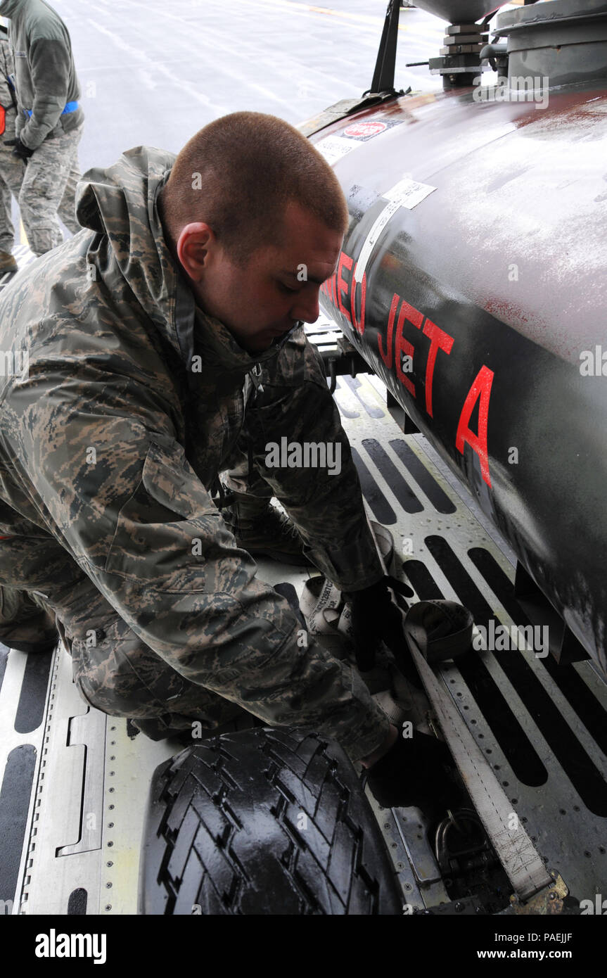 Tech Sgt. Matt Merrow, an Air Transportation Specialist from the 103rd  Airlift Wing at Bradley Air National Guard Base, loads and ties down a  reclaimed jet fuel tank on board a C-5
