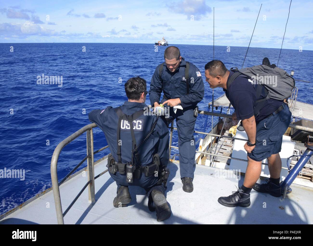 A USCGC Kukui (WLB 203) boarding team discusses emergency position ...