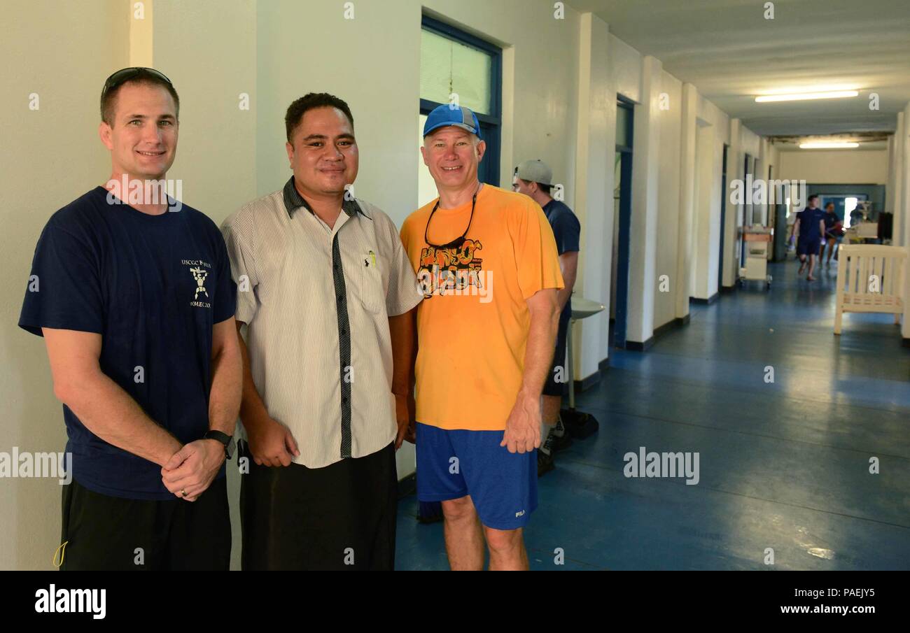 Lt. Cmdr. Brendan Harris, commanding officer of USCGC Kukui (left), poses with Dr. John Lee (center), a doctor, and Lt. Robert Stebe, executive officer, at Prince Wellington Ngu Hospital in Vava’u, Tonga, March 17, 2016. During a port visit, a group of volunteers from Kukui (WLB 203) cleaned and donated cleaning supplies at the local hospital. (U.S. Coast Guard photo by Petty Officer 2nd Class Melissa E. McKenzie/Released) Stock Photo