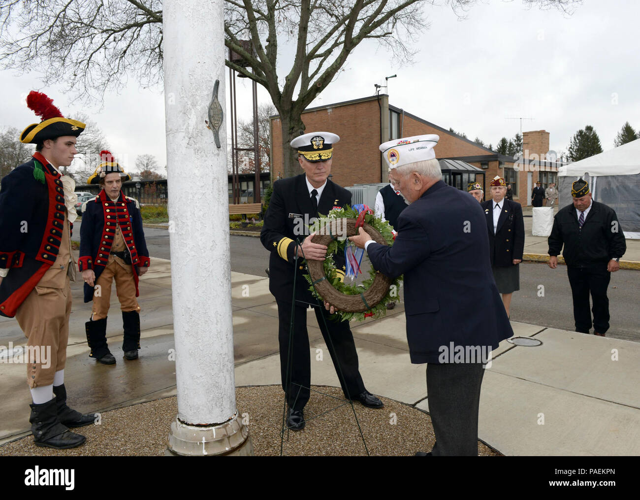 BRISTOL, R.I. (Nov. 11, 2015) Rear Adm. P. Gardner Howe III, president, U.S. Naval War College, and Richard Enos, president, Bristol Veterans Council, participate in a wreath-laying commemoration with Rhode Island veterans during the 2015 Veterans Day ceremony at the R.I. Veterans Home in Bristol, R.I.  In addition to the wreath-laying commemoration, Howe also provided keynote remarks during the ceremony. Stock Photo