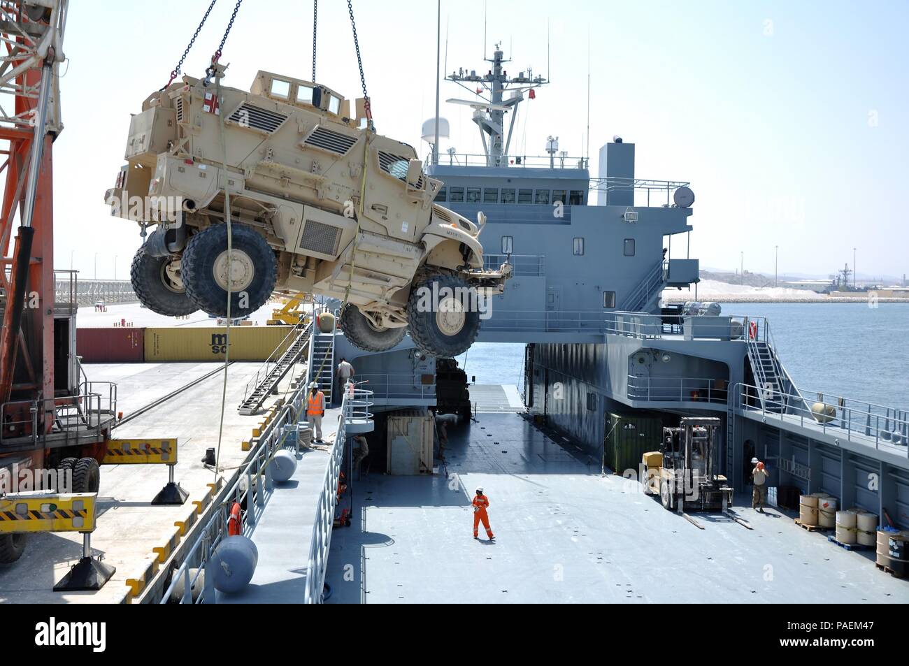 Army mariners with the 1099th Transportation Detachment assigned to the SP4 James A. Loux, Logistics Support Vehicle-6, load an Army vehicle on the main deck during a mission to Port Salalah, Oman, March 6, 2016.  An Army LSV can hold over a dozen U.S. Army M1 Main Battle Tanks. Stock Photo