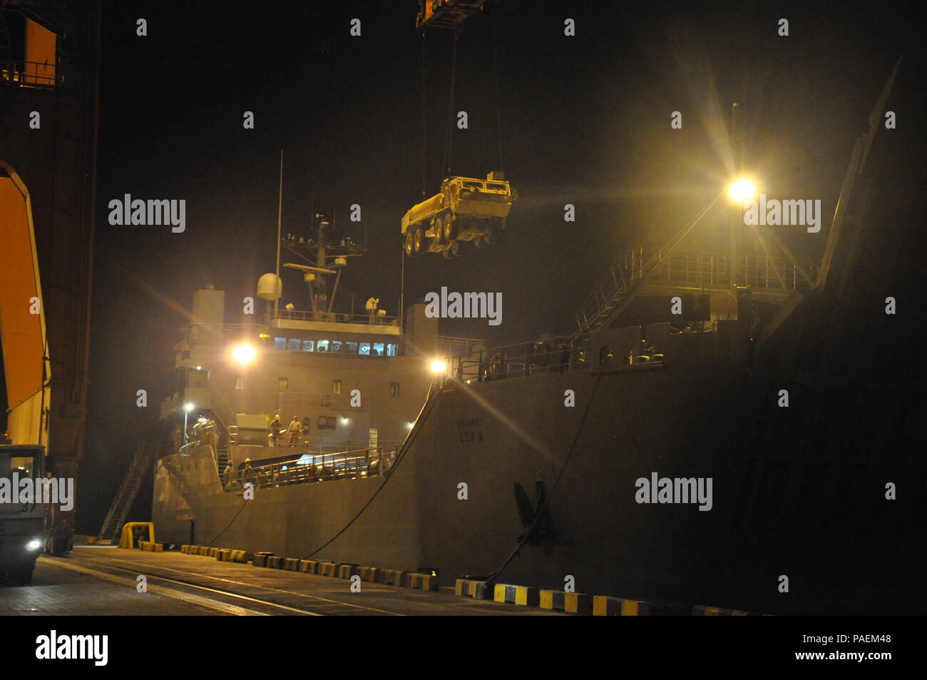 Army Mariners with the 1099th Transportation Detachment assigned to the SP4 James A. Loux, Logistics Support Vehicle-6, loading an Army vehicle on the main deck during a mission to Port Salalah, Oman March 6, 2016.    An Army LSV is specifically designed to hold any vehicle used by the U.S. Army. Stock Photo