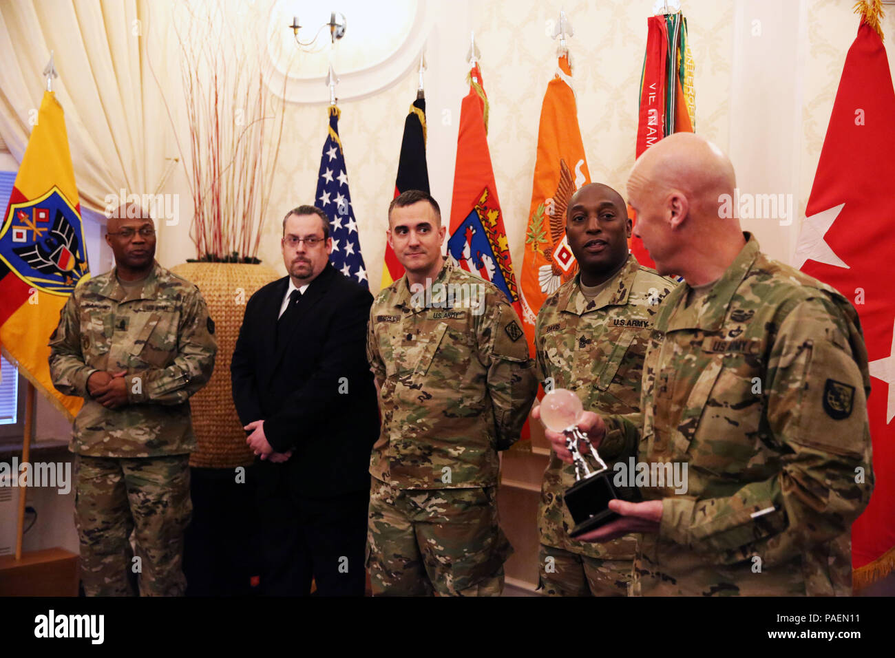 Maj. Gen. John B. Morrison Jr. (far right), commander of U.S. Army Network Technology Command, and Command Sgt. Maj. Stephfon Watson (far left), NETCOM senior enlisted advisor, present the award for 2015 NETCOM NEC of the Year to leaders from the 102nd Signal Battalion, 2nd Signal Brigade at an Orange Call event March 21, 2016 at the Community Activity Center on Clay Kaserne in Wiesbaden, Germany. From center left to center right: James Ellersick, 102nd Signal Battalion regional director; Lt. Col. Chris Keeshan, 102nd Signal Battalion commander; Command Sgt. Maj. Anthony Davis, 102nd Signal Ba Stock Photo