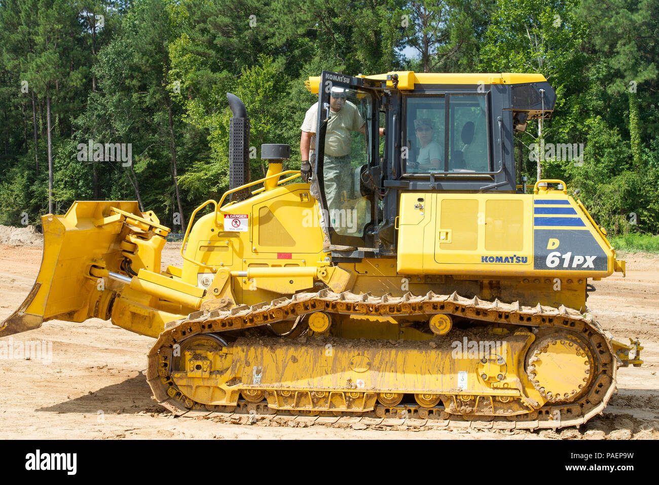 Command Chief of Air Force Reserve Command, Chief Ericka Kelly, sits inside a bull dozer with guidance on how to operate one by U.S. Air Force Tech. Sgt. Jesus Padilla, a heavy equipment operator with the Illinois National Guard's 126th Air Refueling Wing Civil Engineer Squadron, Scott Air Force Base, as part of her tour of Camp Kamassa in Crystal Springs, Mississippi, July 16, 2018. Camp Kamassa will be the states first fully handicap accessible, year round camp facility for children and adults with special needs, that is being built on 326 acres spearheaded by the Department of Defense's Inn Stock Photo