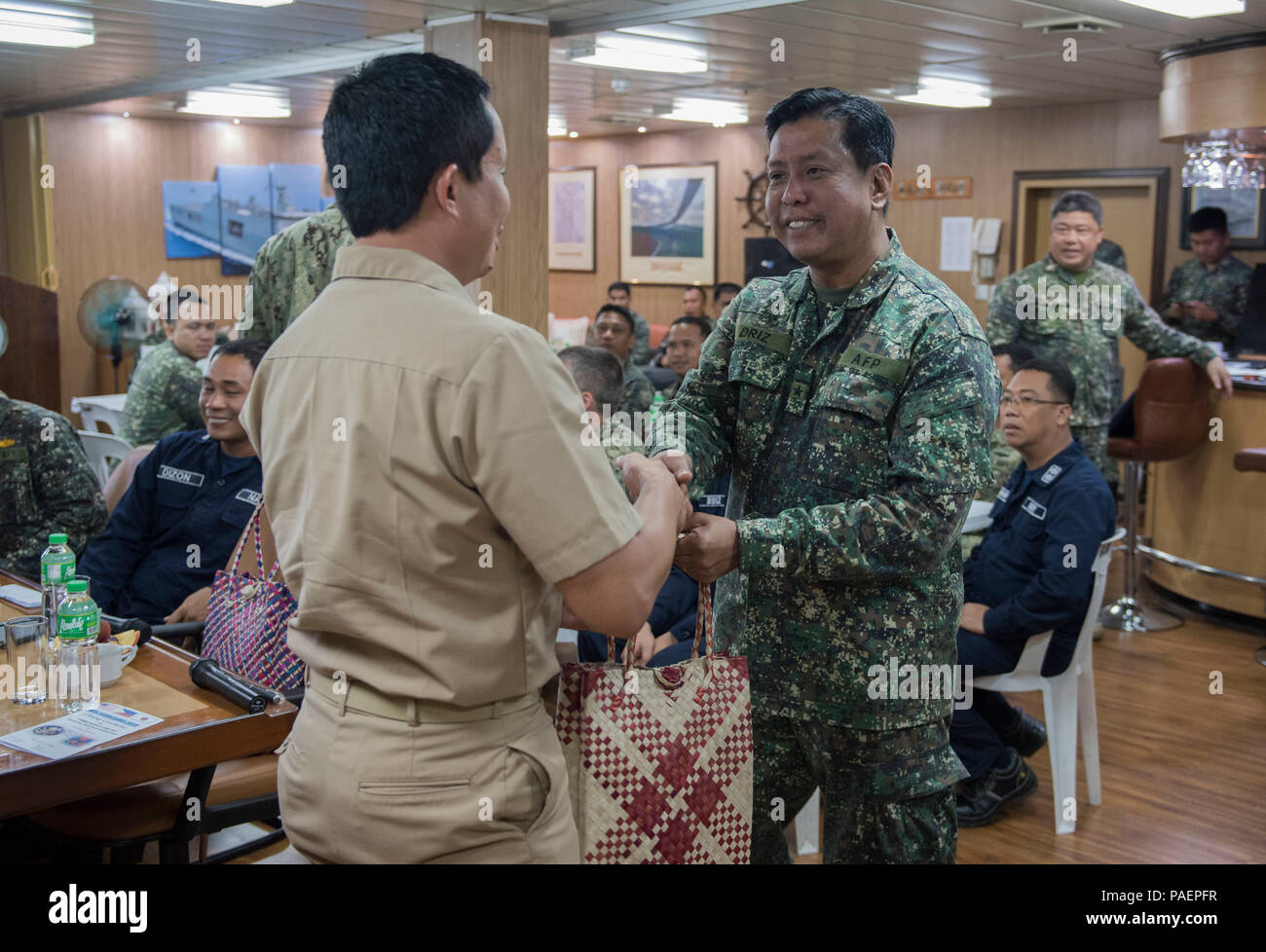 180714-N-OU129-194 SAN FERNANDO CITY, Philippines (July 14, 2018) Captain Erwin Lao, commanding officer of USNS Millinocket (T-EPF 3), exchanges gifts with Philippine Navy Commodore Nichols Driz, Commander, Naval Forces Northern Luzon, at the closing ceremony of Maritime Training Activity (MTA) Sama Sama 2018 aboard Philippine Navy ship BRP Tarlac (LD-601). The week-long engagement focuses on the full spectrum of naval capabilities and is designed to strengthen the close partnership between both navies while cooperatively ensuring maritime security, stability and prosperity. (U.S. Navy photo b Stock Photo
