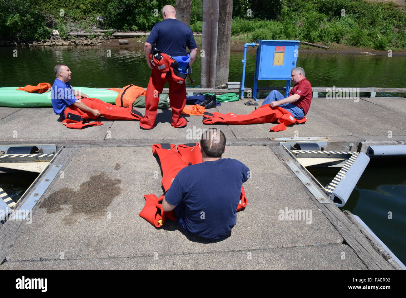 Members of the Washington Homeland Security Roundtable don immersion survival suits commonly known as gumby suits on the floating docks at Marine Safety Unit Portland on the shores of the Willamette River, July 16, 2018.    The WHSR is an organization made up of maritime industry executives and homeland security professionals from across the country.    U.S. Coast Guard photo by Petty Officer 3rd Class Trevor Lilburn. Stock Photo