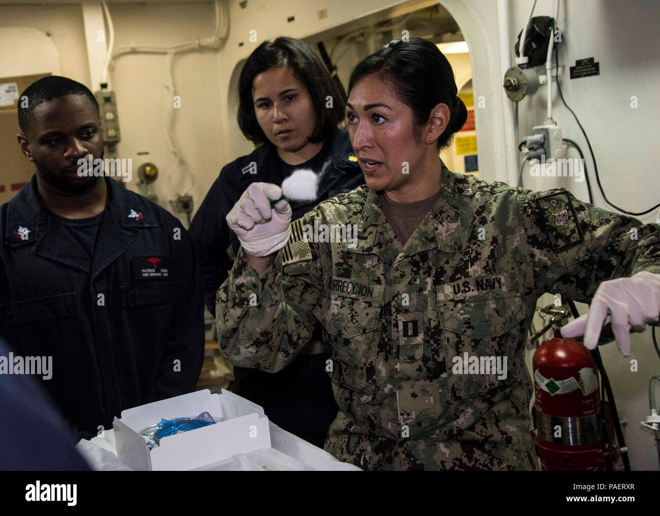 5TH FLEET AREA OF OPERATIONS (May 17, 2018) Lt. Pamela Resurreccion, a trauma nurse assigned to Expeditionary Resuscitative Surgical System 19, explains a foley catheter during a trauma training skills lab in the medical triage ward aboard the Wasp-class amphibious assault ship USS Iwo Jima (LHD 7). Iwo Jima is homeported in Mayport, Fla., and is deployed to the U.S. 5th Fleet area of operations in support of maritime security operations to reassure allies and partners, and preserve the freedom of navigation and the free flow of commerce in the region. Stock Photo