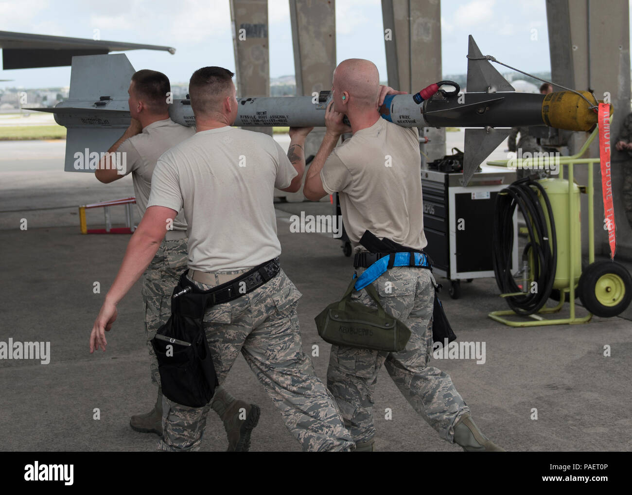 Members of the 44th Aircraft Maintenance Unit carry an AIM-9X heat ...