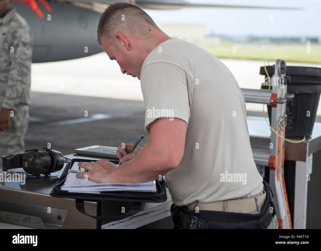 An Airman from the 44th Aircraft Maintenance Unit goes over a checklist ...