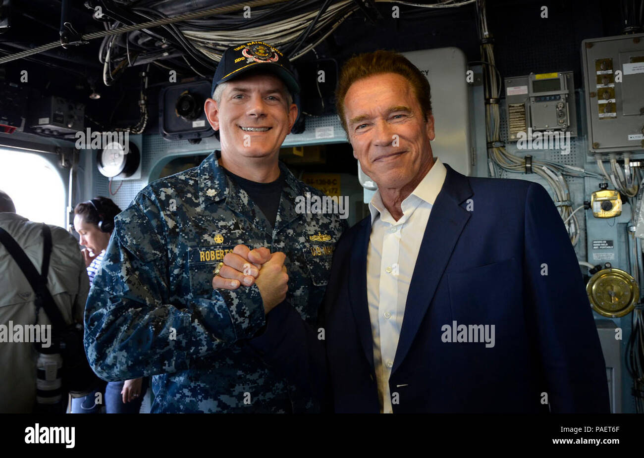 NORFOLK, Va. (June 8, 2016) Former California Governor Arnold Schwarzenegger takes time for a photo with USS Bainbridge (DDG 96) Commanding Officer Cmdr. Martin Robertson aboard the ship, June 8. Schwarzenegger and Assistant Secretary of the Navy for Energy, Installations, and Environment, the Hon. Dennis McGinn visited Naval Station Norfolk for the filming of a National Geographic documentary about the sea-level rise impact to the Navy called “Years of Living Dangerously,” which is scheduled to air in November. Stock Photo