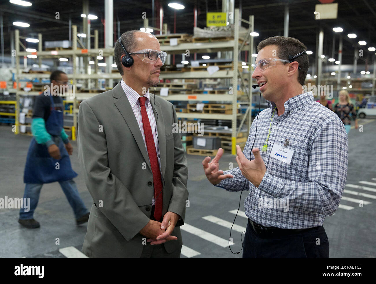 17 August 2015 - Omaha, NE - Labor Secretary Thomas Perez (L) tours the Lozier CorporationХs North Omaha factory with LozierХs Vice President of Operations, David Gnuse (R). The Lozier Corporation is one of the countryХs leading manufacturers of retail store fixtures. The secretary later took part in a roundtable discussion at Lozier with business people, union representatives, community advocates and elected officials who supported the recent Nebraska ballot initiative to increase the stateХs minimum wage. Stock Photo