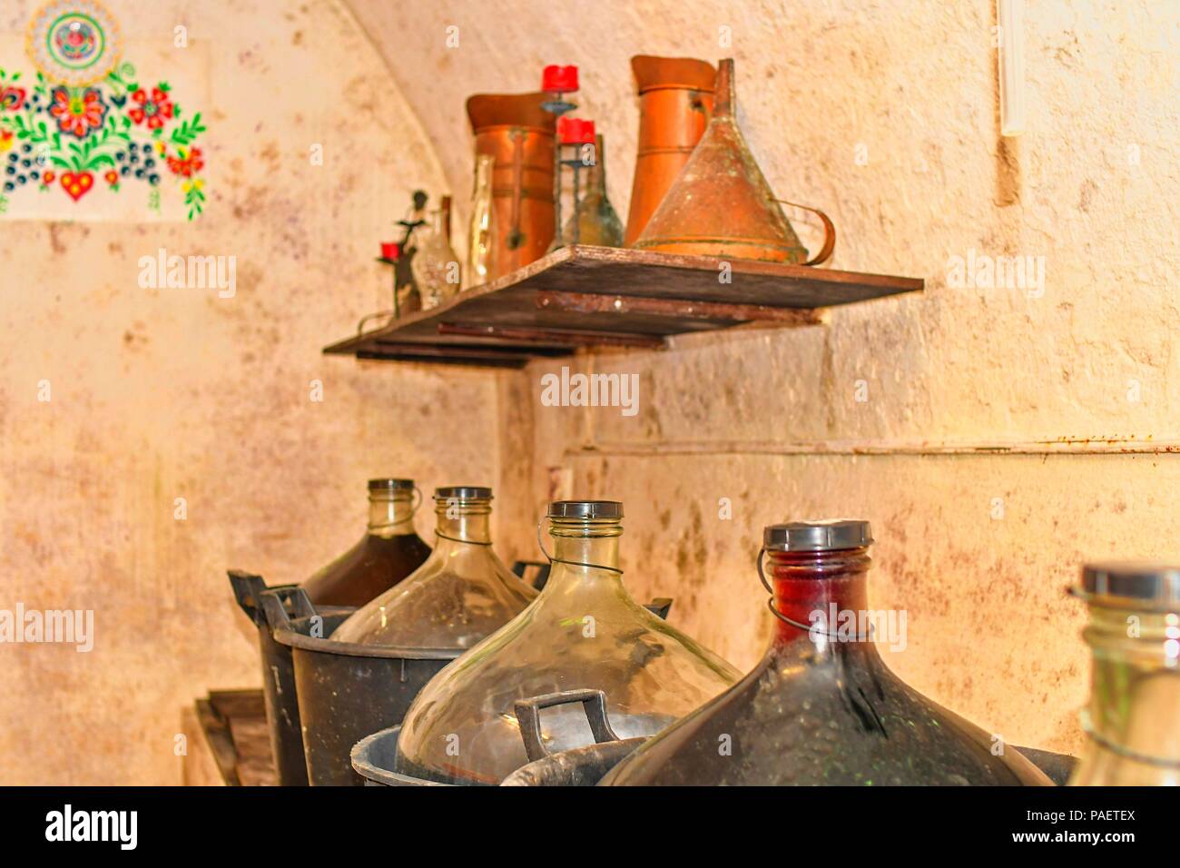 Wine demijohns in Moravian wine cellar. Full carboys of wine