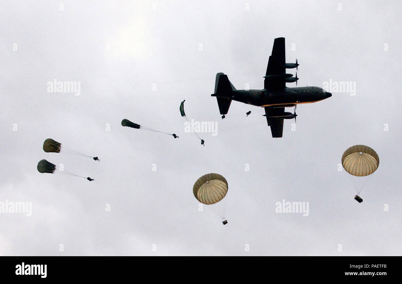 Australian Army Soldiers, 3rd Royal Australian Regiment, conduct a dawn static line parachute jump from a C-130 Hercules cargo aircraft over the Shoalwater Bay Training Area (SWBTA) in Rockhampton, Australia as part of exercise TALISMAN SABRE 2005. TALISMAN SABRE is an exercise jointly sponsored by the US Pacific Command (USPACOM) and Australian Defense Force Joint Operations Command, and designed to train the US 7th Fleet Commander's staff and Australian Joint Operations staff as a designated Combined Task Force (CTF) headquarters. The exercise focuses on crisis action planning and execution  Stock Photo