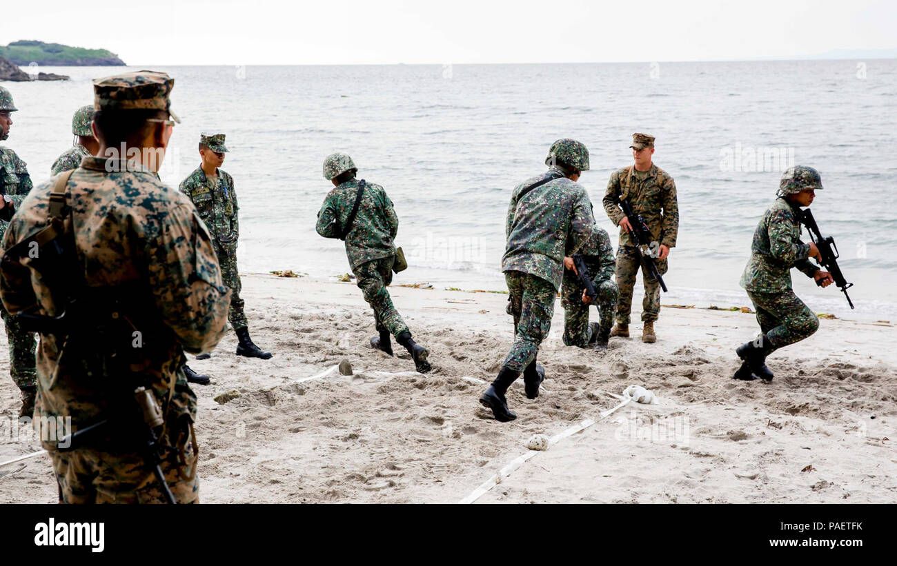 U.S. and Philippine Marines tape off the beach to simulate the dimensions of a room while conducting room clearing exercises at Marine Base Gregorio Lim, Ternate, Philippines, Oct. 2. The Marines are participating in KAMANDAG, a bilateral exercise that increases the ability of the U.S. and the Philippines to rapidly respond to terrorist threats and humanitarian crises. KAMANDAG is an acronym for the Filipino phrase 'Kaagapay Ng Maddirigma Ng Dagat,' which translates to 'Cooperation of Warriors of the Sea.' Stock Photo