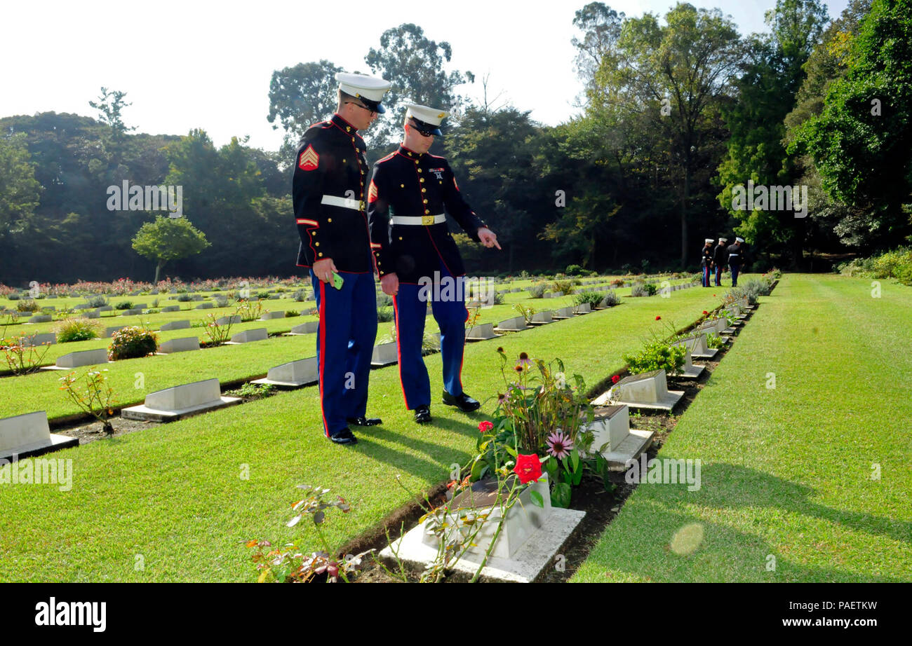 HODOGAYA, Japan (Oct. 12, 2015) - Sgt. Kyle Froelich (left) and Sgt. Allen Heiner, assigned to Fleet Anti-Terrorism Security Team Pacific (FASTPAC), read various prisoners-of-war grave inscriptions at the Commonwealth War Cemetery while participating in the 6th annual service of reconciliation, as part of the Japanese/ POW(s)Friendship Program. The cemetery has 1,555 Second World War burials from United Kingdom, Australia, India, Netherlands, New Zealand and Canada. Stock Photo