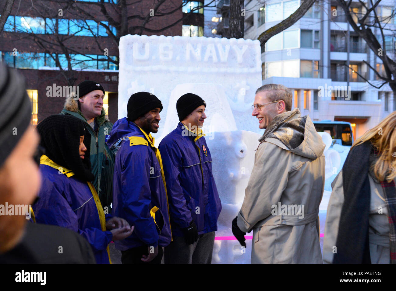 SAPPORO, Japan (Feb. 8, 2016)  Vice Adm. Joseph Aucoin, commander of U.S. 7th Fleet, interacts with Sailors from Misawa Air Base next to a surface warfare pin snow sculpture that the Sailors created for the 67th Annual Sapporo Snow Festival. The pin was carved in honor of the prestigious warfare program and the stellar Sailors who have attained the qualification. This is the 33rd consecutive year that the U.S. Navy has sent a team of Sailors to participate in the festival. Stock Photo