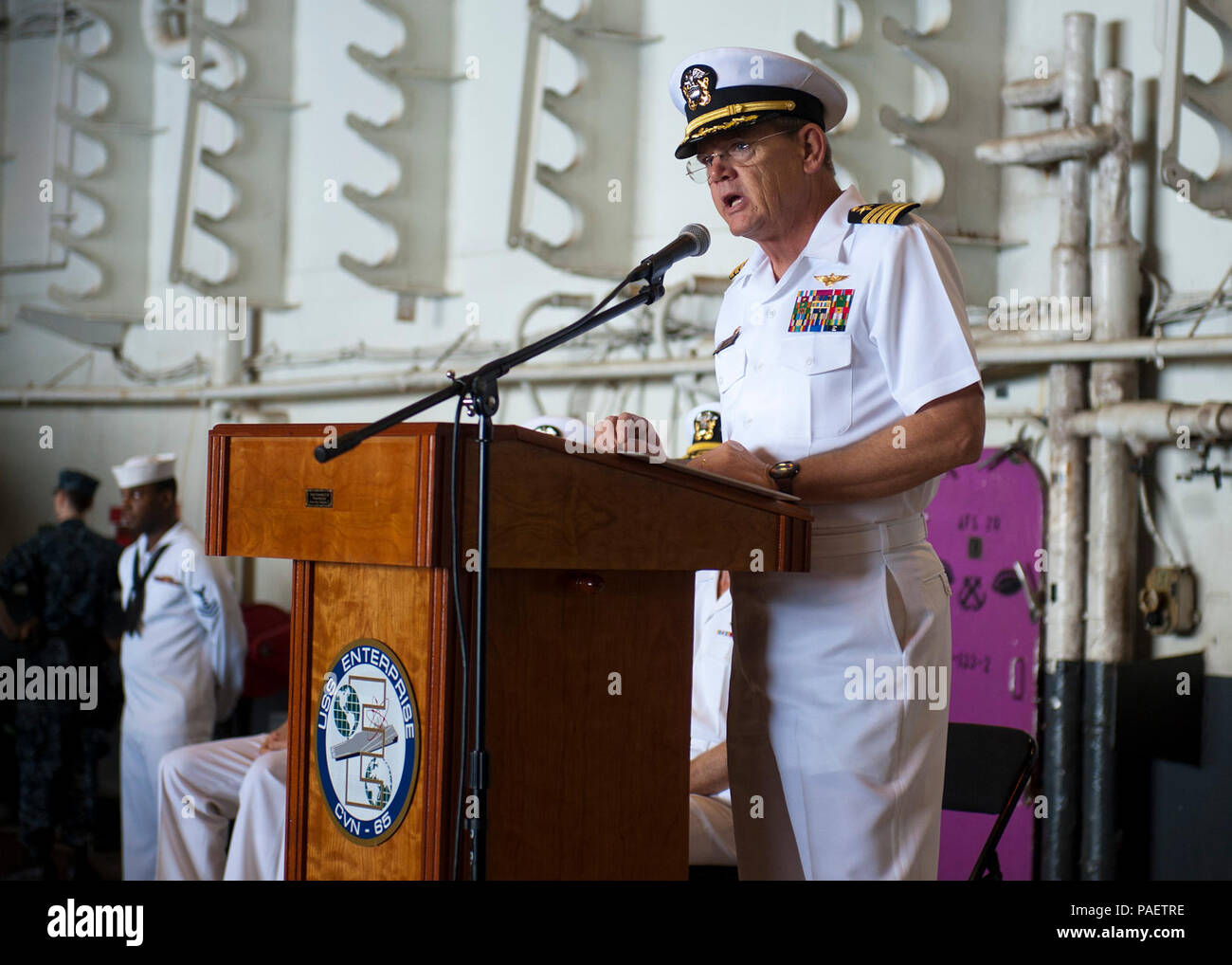Capt. William C. Hamilton Jr., commanding officer of the aircraft carrier USS Enterprise (CVN 65), addresses the crew during a ceremony commemorating the Sept. 11, 2001, terrorist attacks. Enterprise is deployed to the U.S. 5th Fleet area of responsibility conducting maritime security operations, theater security cooperation efforts and support missions as part of Operation Enduring Freedom. Terrorists hijacked four passenger aircraft Sept. 11, 2001. Two of the aircraft were deliberately crashed into the World Trade Center in New York; one was crashed into the Pentagon; the fourth crashed near Stock Photo