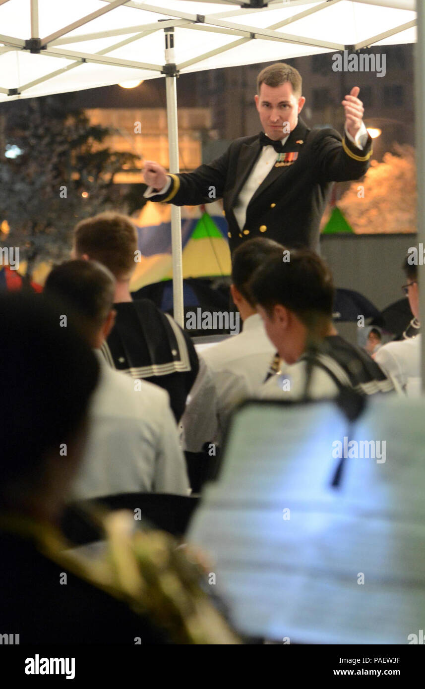 JINHAE, Republic of Korea (April 2, 2015) Lt. Brian Chaplow, fleet bandmaster of U.S. 7th Fleet Band, conducts Korean Navy band members from Jinhae Naval Base and musicians from U.S. 7th Fleet Band in a joint outdoor concert during the 53rd annual Jinhae Cherry Blossom Festival, April 2. Comprised of professional Navy musicians, the U.S. Navy 7th Fleet Band embarks aboard USS Blue Ridge (LCC 19), flagship for the U.S. 7th Fleet, during deployments and has performed for thousands of audiences throughout the Indo-Asia-Pacific region. Stock Photo