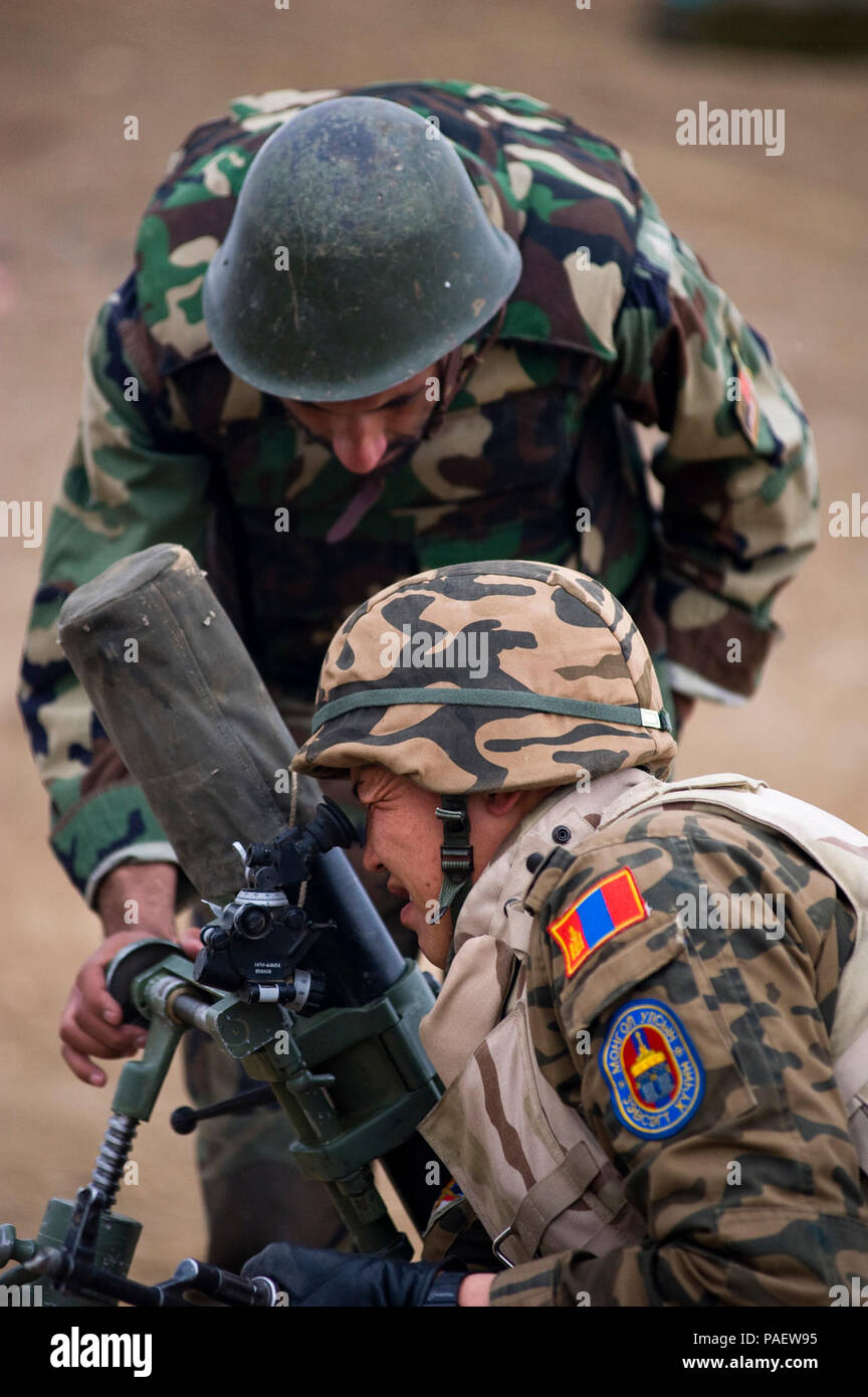 KABUL, Afghanistan (Feb. 2, 2011) - A Mongolian adviser, bottom, and Afghan National Army instructor sight an 82mm mortar at an infantry branch school range Feb. 2, 2011 in Kabul, Afghanistan. NATO Training Mission-Afghanistan advisers provide guidance to Afghan National Army instructors charged with conducting the bulk of training. Stock Photo